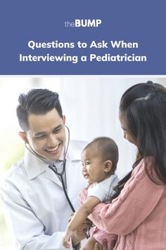 a doctor is talking to a baby while holding it's head in her hands