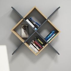 a book shelf with books and magazines on it in the shape of four intersecting cubes