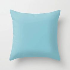 a light blue pillow on a white wall with an empty space for the text or image