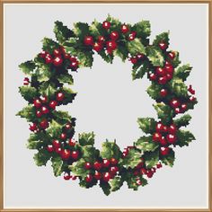 a cross stitch christmas wreath with holly berries