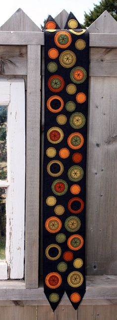 a black tie with orange, yellow and green circles hanging from it's side