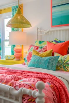 a bedroom with bright colored bedding and colorful lamps hanging from the ceiling above it