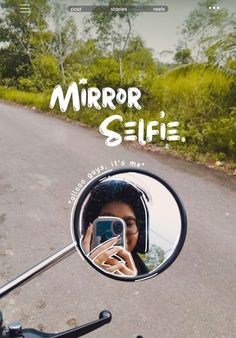 a woman taking a selfie in the mirror of a motorcycle