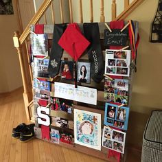 a wall with pictures and photos on it in the hallway next to a stair case