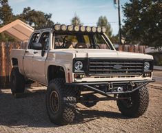 a white truck parked on top of a gravel road