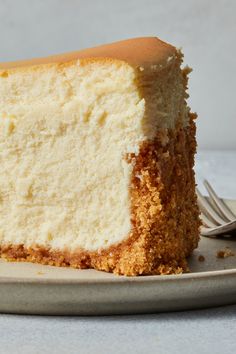 a piece of white cake on a plate with a fork next to it and the rest of the cake is missing