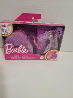 the barbie doll is in its pink box