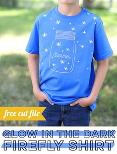 a young boy wearing a blue shirt that says glow in the dark firefly shirt