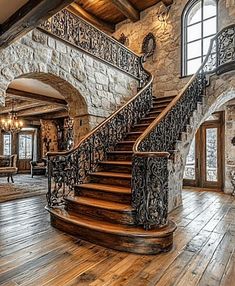 a large staircase in the middle of a stone and wood building with arched windows on both sides