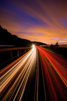 an aerial view of the highway at night with long exposure and light streaks in the foreground