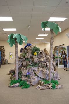 an office decorated with paper mache and palm trees