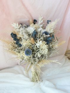 a bouquet of flowers sitting on top of a bed