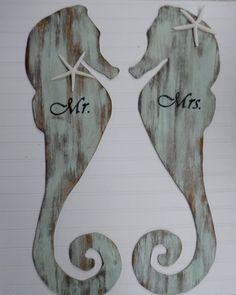 two seahorses with the words mr and mrs written on them, are shown