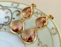 READY TO SHIP! Blush Champagne Earrings Peach Gold Two Tier Teardrop Studs Posts - Blush Earrings Bridesmaid Jewelry Peach Wedding Earrings Wedding Jewelry ***BEST SELLER in my shop for weddings, bridesmaids, and gifts*** The bottom large champagne blush teardrop gem is 15mm x 18.5mm and is gold plated. The top champagne teardrop measures 14mm x 11mm and has a sterling silver post attached. The length of the earrings is a little over 1.5 inches long. These earrings are simply stunning! You are s Orange Teardrop Jewelry For Wedding, Elegant Peach Earrings For Wedding, Orange Drop Earrings For Wedding, Elegant Peach Wedding Earrings, Elegant Apricot Dangle Earrings, Elegant Apricot Earrings For Gift, Elegant Apricot Dangle Jewelry, Elegant Orange Teardrop Earrings, Peach Dangle Jewelry For Wedding