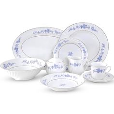 a white and blue dinnerware set with flowers on it