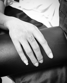 a woman's hand with a small tattoo on it