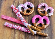 some pretzels are decorated with sprinkles and hearts