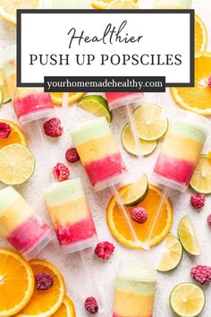 popsicles with raspberries, limes and lemon slices on them are shown