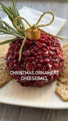 christmas ornament cheeseball on a plate with crackers