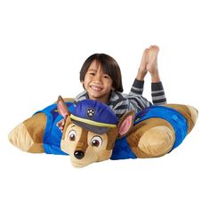 a young boy laying on top of a stuffed animal