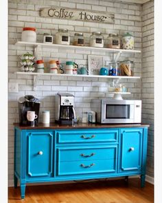 an image of a kitchen with blue cabinets and white appliances on the wall above it