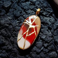 "Welcome to APRAZITA Discover our unique Kintsugi-Inspired Gemstone Jewelry Collection. Kintsugi is a revered Japanese art of mending broken pottery with gold-infused lacquer, transforming flaws into beautiful, valuable features. At APRAZITA, we apply this same process to repair gemstones, infusing them with renewed beauty and significance. Modern kintsugi repairs each gemstone with epoxy paste and gold leaf, symbolizing the beauty in healing life's broken places. Each kintsugi-repaired gemstone is one-of-a-kind due to the process's randomness. The pictured jewelry is the one you'll receive. Take a closer look at each image to fully appreciate the distinctive intricacies of this remarkable gemstone. Our dedication to merging gemstones with other art forms is truly exceptional. 🔹 ITEM DETA Kintsugi Earrings, Heart Necklace Locket, Kintsugi Jewelry, Locket Vintage, Necklace Locket, Embrace Imperfections, Jasper Jewelry, Mookaite Jasper, Meaningful Jewelry