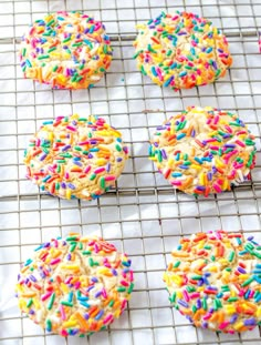 sprinkle covered cookies cooling on a wire rack