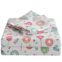 a white sheet set with donuts and lollipops printed on the sheets