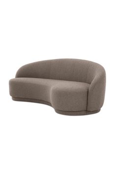 the curved sofa is made out of fabric and has a rounded back, with an extended arm