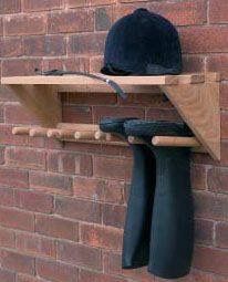 a hat and glove rack on a brick wall next to a pair of black gloves