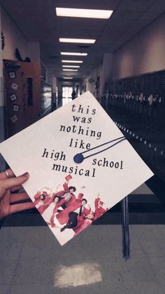 someone holding up a graduation cap that says, this is nothing like high school musical