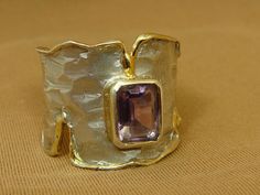 "Photos are enlarged to show detail. All measurements are approximate. Sterling silver rhodium plated ring with gold plated accents set with a genuine purple amethyst (approx 1 1/2 cts) by Juvite. This unique, contemporary, European design ring was hand crafted, and retails for more than $300. Currently a size 7 1/2 on our mandrel (mandrels may differ slightly). This ring doesn't show any wear at all, as you can see from the photos. (The white on the stone is just a spec of dust, and not a scrat Gold Amethyst Jewelry With Stone Setting, Gold Amethyst Ring With Modern Style, Gold Amethyst Ring With Polished Finish As Gift, Gold Sterling Silver Fine Jewelry Amethyst Ring, Gold Amethyst Ring In Sterling Silver Fine Jewelry, Gold Amethyst Ring In Sterling Silver, Unique Gold Amethyst Ring Hallmarked, Gold Amethyst Jewelry With Polished Finish, Unique Gold Amethyst Ring With Hallmark