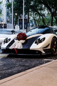 a white and black sports car parked on the street