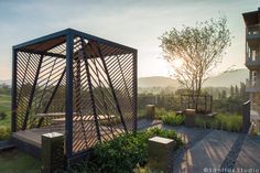 a wooden structure sitting on top of a lush green field