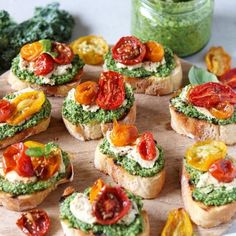 small sandwiches with tomatoes and pesto on them