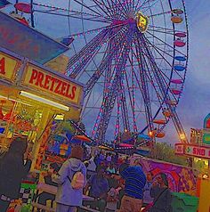 people are standing in front of a carnival ferris wheel at night with lights on it