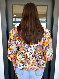 The Leni Top is a trendy floral print blouse with a chic bow tie at the front for a touch of whimsy. Its pleated shoulder and mid puff sleeves give this blouse a unique and playful look. Completed with a clean scallop hem and convenient tie straps, it's the perfect addition to your wardrobe. Chelsea is wearing a size Large. Height is 5’8”, Bust is 36”, Waist is 29. Feminine Ditsy Floral Print Blouse For Garden Party, Floral Print Blouse For Garden Party, Chic Flowy Top For Garden Party, Flowy Floral Print Blouse For Brunch, Feminine Puff Sleeve Blouse For Garden Party, Patterned Floral Print Top For Brunch, Floral Print 3/4 Sleeve Work Blouse, Floral Print Workwear Blouse With 3/4 Sleeves, Multicolor Puff Sleeve Blouse For Spring