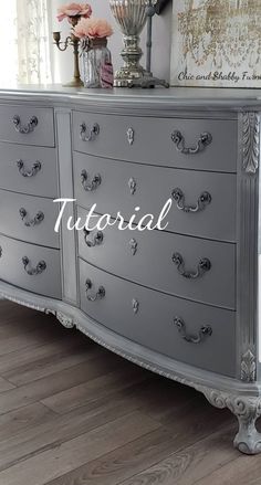 a large gray dresser sitting on top of a wooden floor