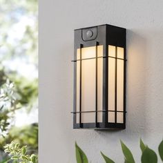 an outdoor light mounted on the side of a wall