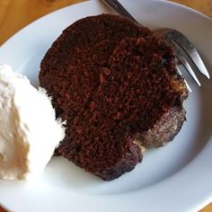 a piece of chocolate cake and ice cream on a white plate with a silver fork