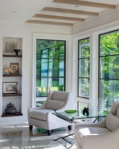 a living room filled with furniture and windows