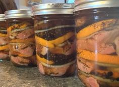 jars filled with food sitting on top of a counter