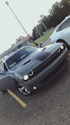 two cars parked in a parking lot next to each other