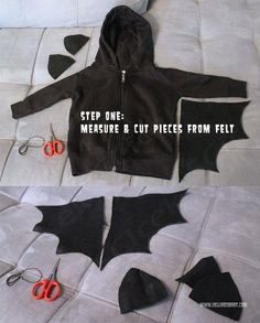 an image of a bat cut out on the floor with scissors and fabric to make it look like they're ready for halloween