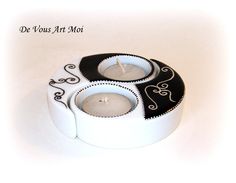 a candle holder with two candles in it on a white surface, and the words do vous art moi written below