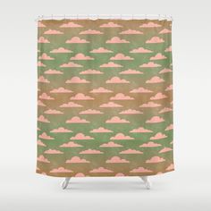 a shower curtain with pink and green clouds on it