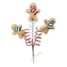 three gingerbread men on top of a christmas tree