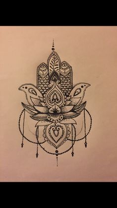 a drawing of a hamsah with beads on the bottom and an intricate design in the middle