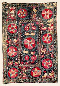 an old rug with hearts and flowers on it's sides, in red and blue colors