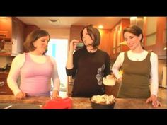 three women standing in a kitchen preparing food